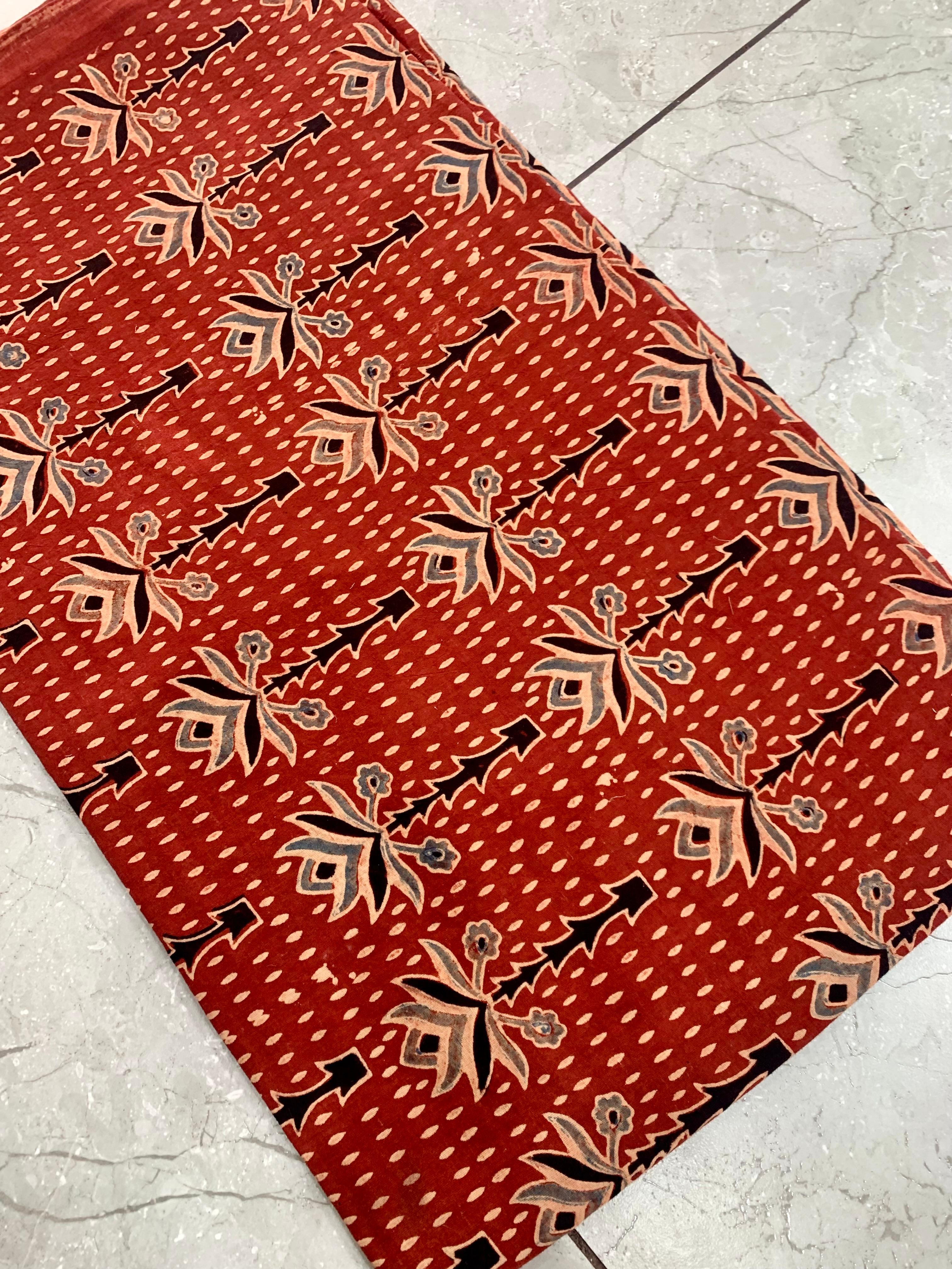 Maroon tree-motif Ajrakh handblock printed cotton wholesale fabric inspired by traditional Kutch symbols.